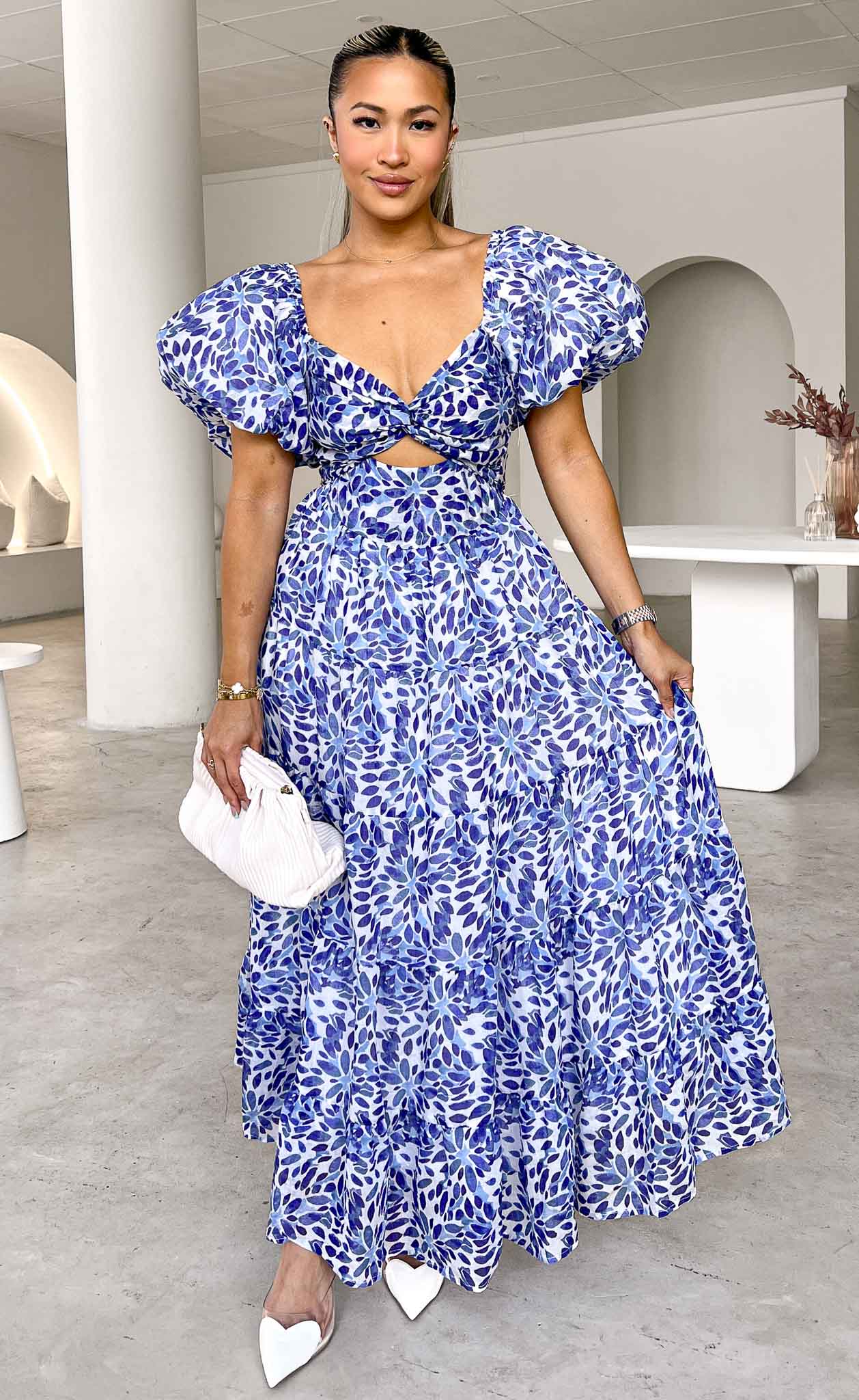 https://cdn.shopify.com/s/files/1/0601/7243/5517/files/BRETTA-SWEETHEART-TWIST-CUT-OUT-PUFF-SLEEVE-MAXI-DRESS-BLUE-PRINT.jpg?v=1726803685